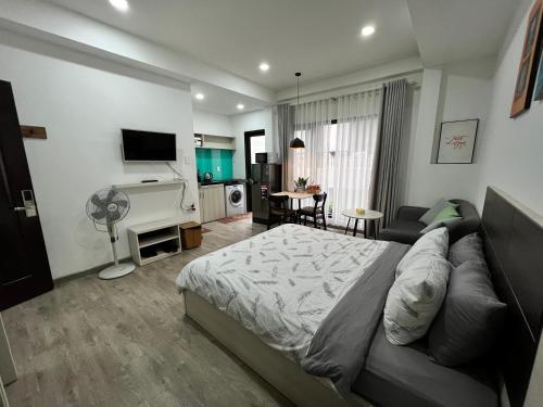 a bedroom with a bed and a living room at May Studio in Da Lat