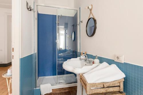 a bathroom with a sink and a shower at Angelina Dimora Contemporanea in Rome