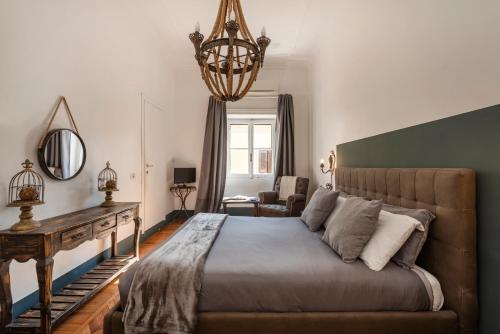 ローマにあるAngelina Dimora Contemporaneaのベッドルーム1室(大型ベッド1台、シャンデリア付)
