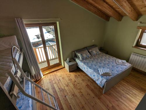 a bedroom with a bed and a balcony at CONSTANCIA TRATTORIA in Valdieri