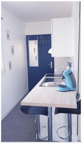 - une cuisine avec une table et un ordinateur portable dans l'établissement Studio avec balcon, à Dunkerque