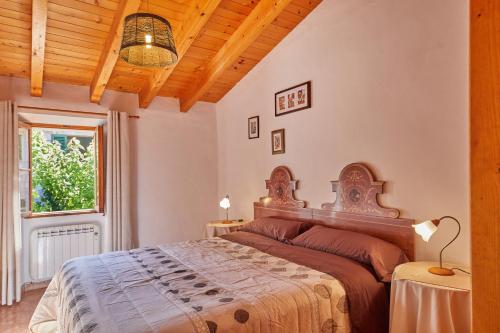 a bedroom with a large bed and a window at Casa Fortuny in Soller in Sóller