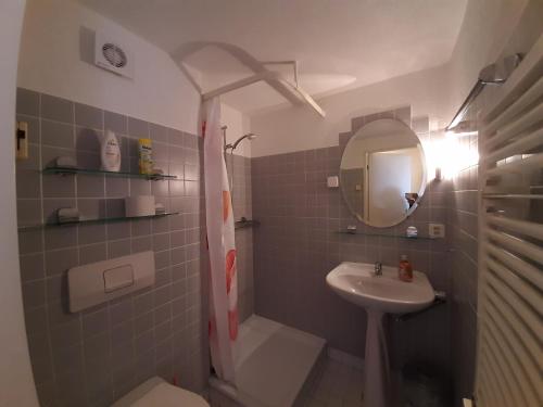 a bathroom with a sink and a toilet and a mirror at Lake Guest Haus in Därligen