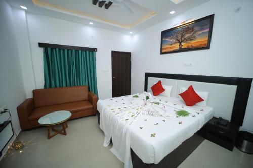 a hotel room with a bed and a chair at THE HOTEL PARADISE in Gorakhpur