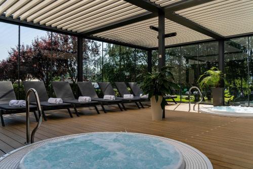 a patio with a bunch of chairs and a table at Artis Loft Hotel in Radziejowice