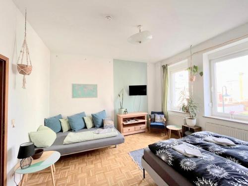 a living room with a couch and a bed at Appartement Buntspecht in Erfurt