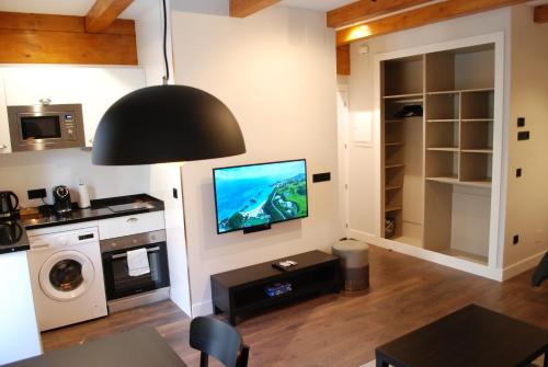 a living room with a flat screen tv on a wall at Altar Suites Caño Badillo by gaiarooms in León