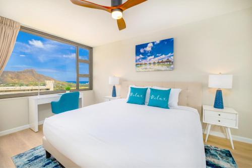 a bedroom with a white bed and a large window at Fabulous Ocean & Diamond Head View with Free Parking! in Honolulu