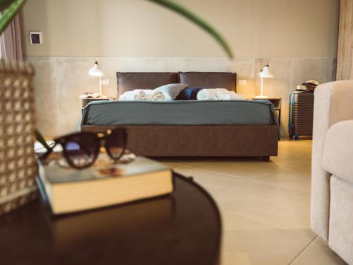 a bedroom with a bed and a table with glasses on it at B&B Casa di Gio' in Tiggiano