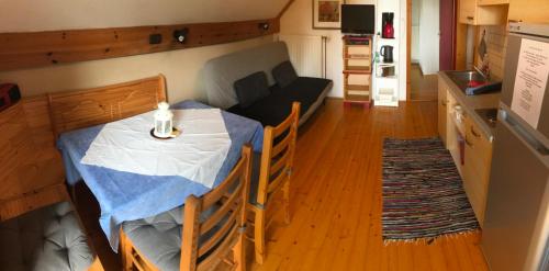 a small room with a table and a couch at Georgihof im Park in Unterburg am Klopeiner See
