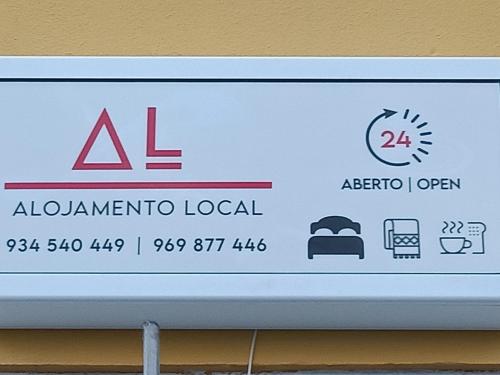 a sign for aldermanato local on a wall at Alojamento Local Largo da Igreja in Santiago do Cacém