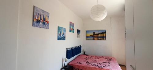 a bedroom with a bed and pictures on the wall at Attico Ostia in Lido di Ostia