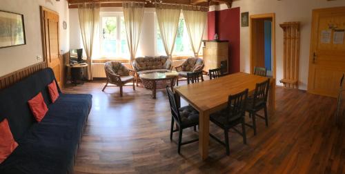 a living room with a table and chairs at Georgihof im Park in Unterburg am Klopeiner See