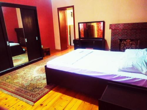 ein Schlafzimmer mit einem großen Bett und einem Kamin in der Unterkunft KOSHGARI APARTMENT in Samarkand
