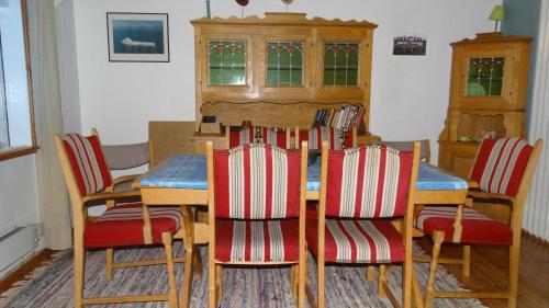 a dining room with a table and four chairs at Hótel Djúpavík in Djupavik