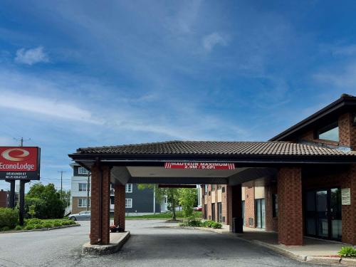 a gas station with a sign in front of it at Econo Lodge Airport Quebec in Quebec City
