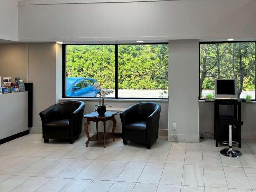 an office with two chairs and a table and a window at Econo Lodge Airport Quebec in Quebec City