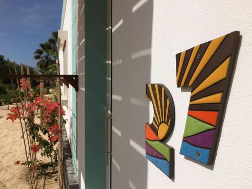 a building with colorful stained glass panels on the side of it at Vila Mare - Praia de Chaves frontline in Cabeçadas