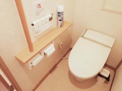 a bathroom with a white toilet in a room at abc OSAKA in Osaka