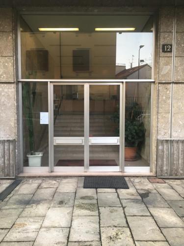 an entrance to a building with a glass door at Morivione Apartment - Bocconi free parking in Milan