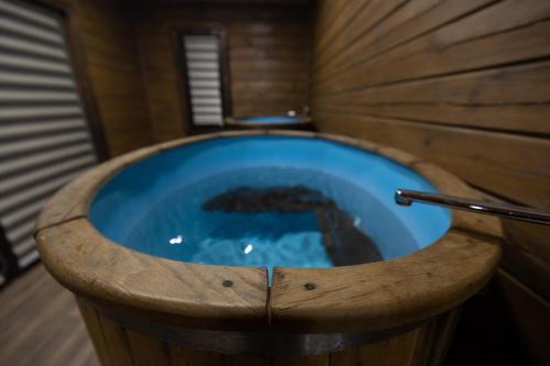 a large wooden bath tub in a wooden bathroom at Lake Park in Novomoskovsʼk