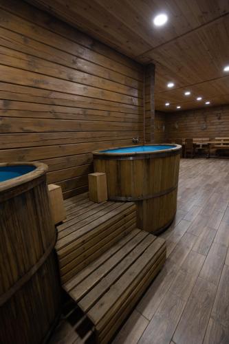 a sauna with two juzzles in a wooden room at Lake Park in Novomoskovsʼk