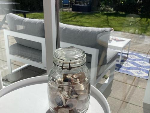 a jar of shells sitting on a table on a patio at Zeebries in Makkum