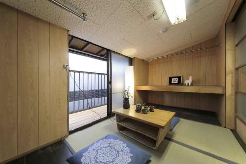 a room with a table and a large window at Osaka SENJU2 traditional Tatami whole house 2-5 ppl 3 mins walk to station in Osaka