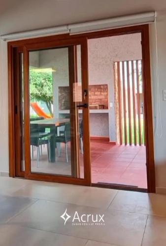 a sliding glass door to a dining room with a table at Casas Acrux in Nono