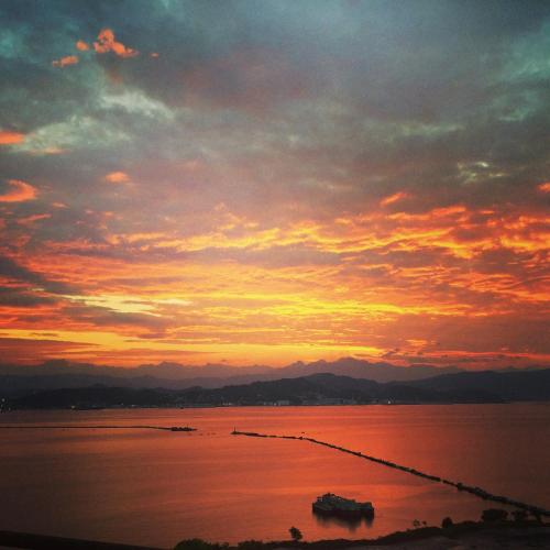 a sunset over a large body of water at Jolly Roger Affittacamere in La Spezia