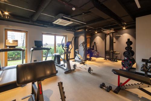 a gym with several treadmills and machines in a room at Maya's Flats & Resorts 18 - Nadmotlawie in Gdańsk