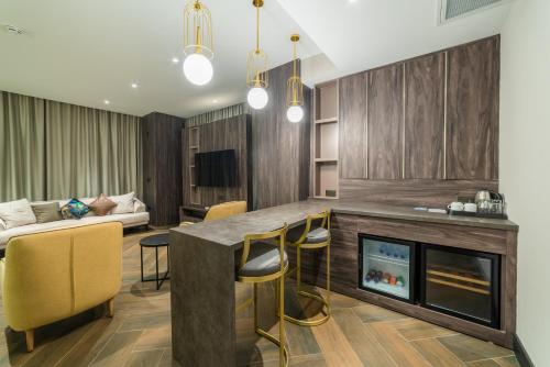 a living room with a table and a fireplace at Hotel Pia Bella in Kérynia