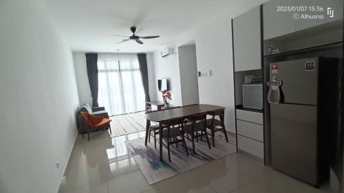 a kitchen and dining room with a table and a refrigerator at Grand View House GVH in Bandar Penawar