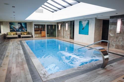 a large swimming pool in a hotel room with at Van der Valk Hotel Oostzaan - Amsterdam in Oostzaan
