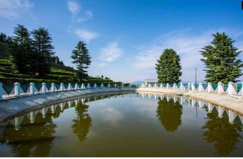 a bridge over a body of water at Norvin Homes in Shimla