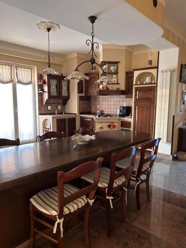 a kitchen with a large wooden table and chairs at Casa Giò in Ariano Irpino