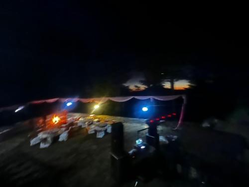 a group of tents with lights at night at Norvin Homes in Shimla