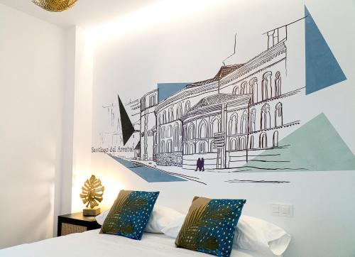 a bedroom with a drawing of a building on the wall at Cervantes 5 Collection Delux - Toletum in Toledo