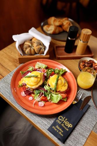 a plate of food on a table with a plate of food at Chop Old House Hotel in Velika Gorica