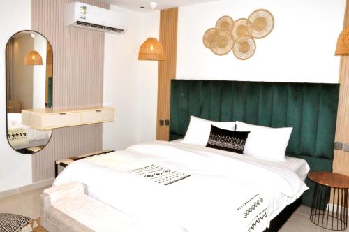 a bedroom with a large bed with a green headboard at مساكن الدار للشقق الفندقية 10 in Abha