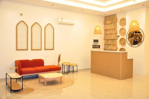 a living room with a red couch and a table at مساكن الدار للشقق الفندقية 10 in Abha