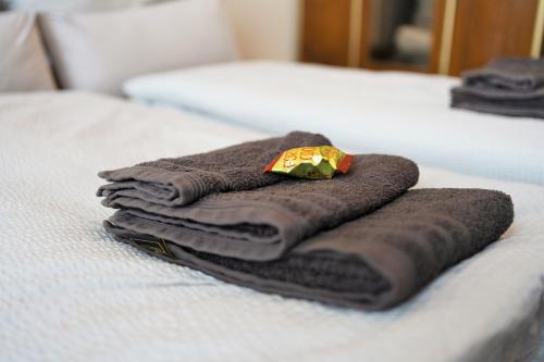 a pile of towels sitting on top of a bed at EXKLUSIV home & business Deluxe Kregel Apartment 70qm in Leipzig