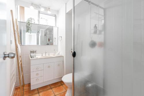 a bathroom with a shower and a toilet and a sink at Fresh 2BD Koala Condo West End in Brisbane