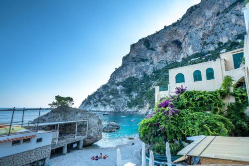 a view of a beach next to a mountain at Capri room on the beach in Capri