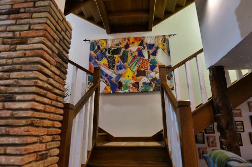 a hallway with a staircase with a mosaic wall at La Sinagoga in Peñaranda de Duero
