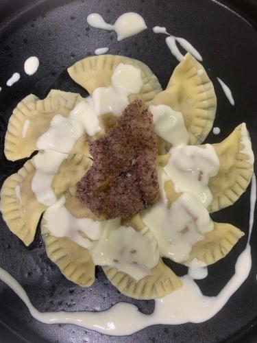 a plate of food with a piece of cake and cream at Pernice 77 in Sulzano