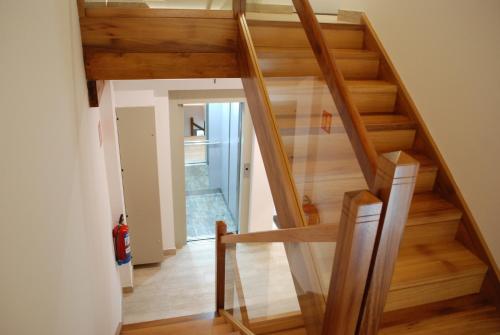 a staircase in a house with wooden floors at Altar Suites Caño Badillo by gaiarooms in León