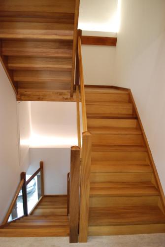 a staircase in a house with wooden floors at Altar Suites Caño Badillo by gaiarooms in León