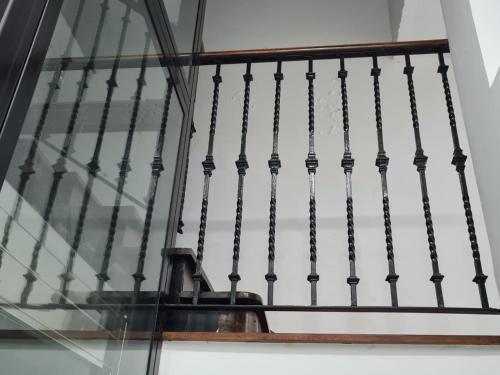 a set of stairs with a glass railing at 1930 Diecinueve Treinta "Diseño, historia y confort en el centro de Gijón" in Gijón