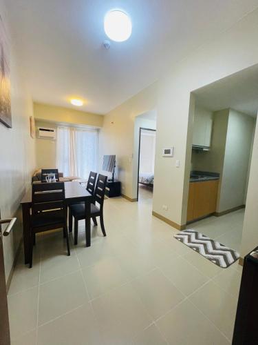 a kitchen and dining room with a table and chairs at 1 Bedroom Condo unit @ Iloilo Business Center in Iloilo City